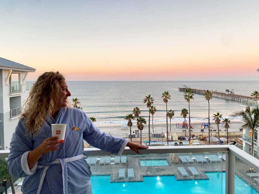 The author in Seabird Resort's balcony with the ocean view at sunset