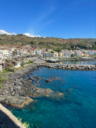 View of a seaside town in Aci Castello, seen from the top of a hill