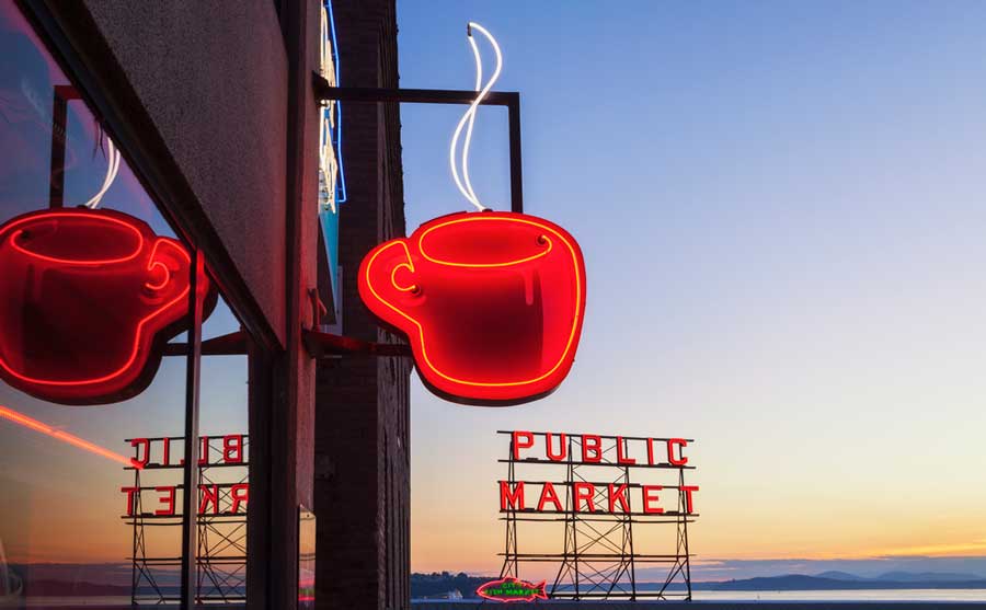 A cup of coffee neon sign displayed outside a cafe