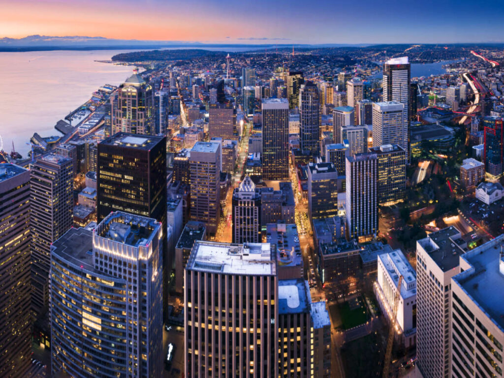 Overlooking view of downtown Seattle, Elliott Bay, Lake Union, and other skyscrapers from Sky View Observatory at dusk