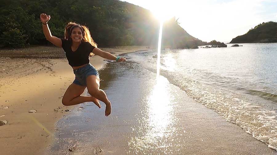 The author's wife posing for a photo in a secluded beach