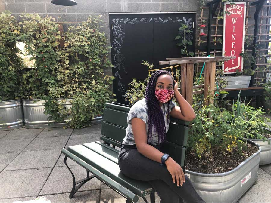 The author posing for a photo while sitting in the Secret Garden