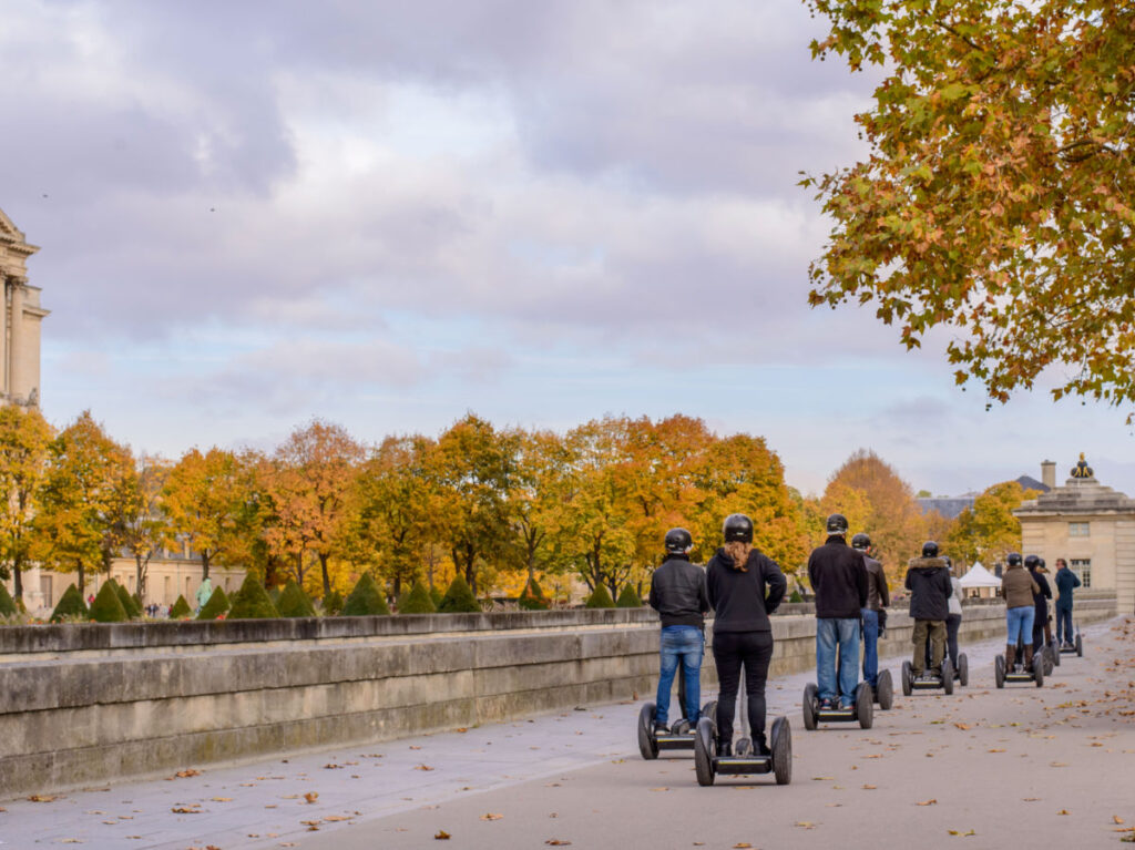 Tour groups of tourists in a Segway on the streets of Paris in the autumn