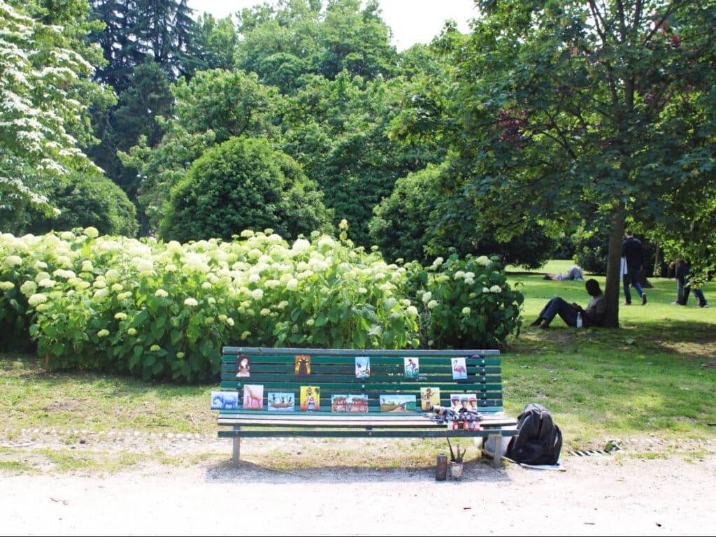 A bench with artworks for sale in Sempione Park