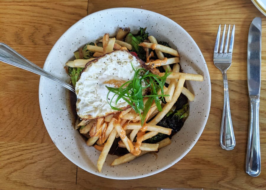 A dish topped with fries and egg in Señor Bear