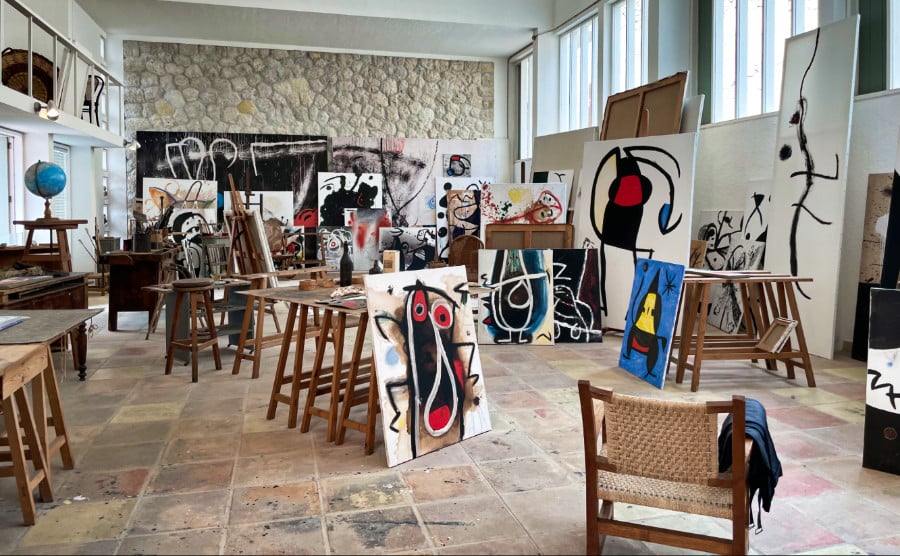 View inside an art studio with artwork on canvasses around