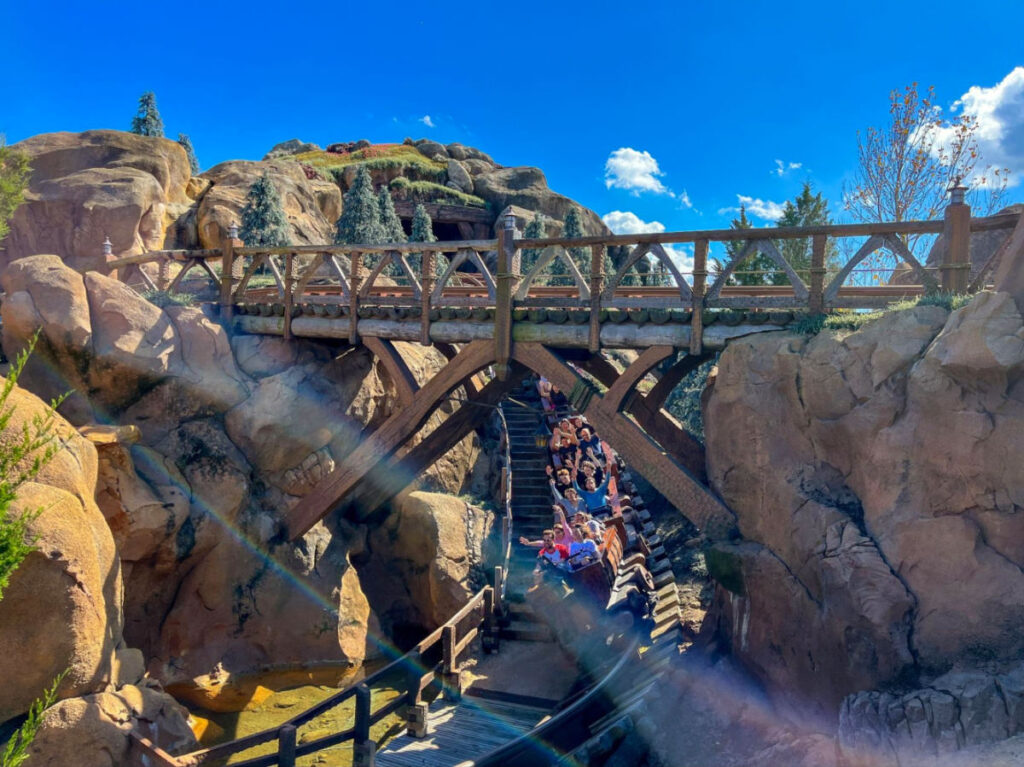 View of people enjoying the ride at Seven Dwarfs Mine Train