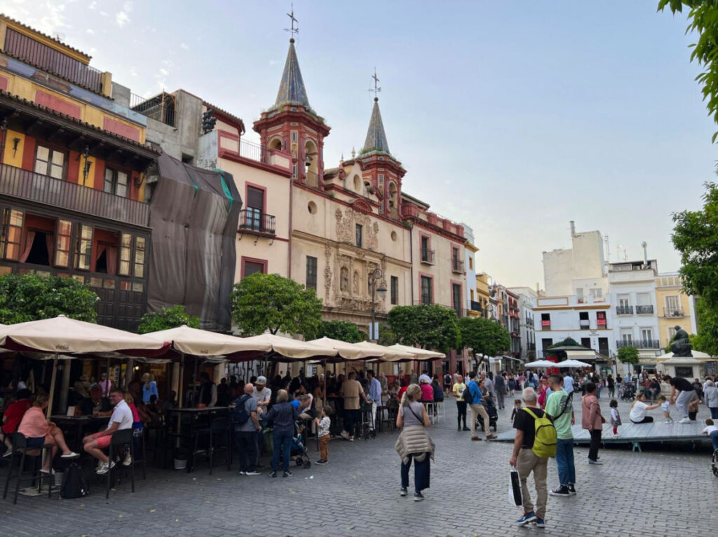 Vibrant plaza in Seville's city center, bustling with people