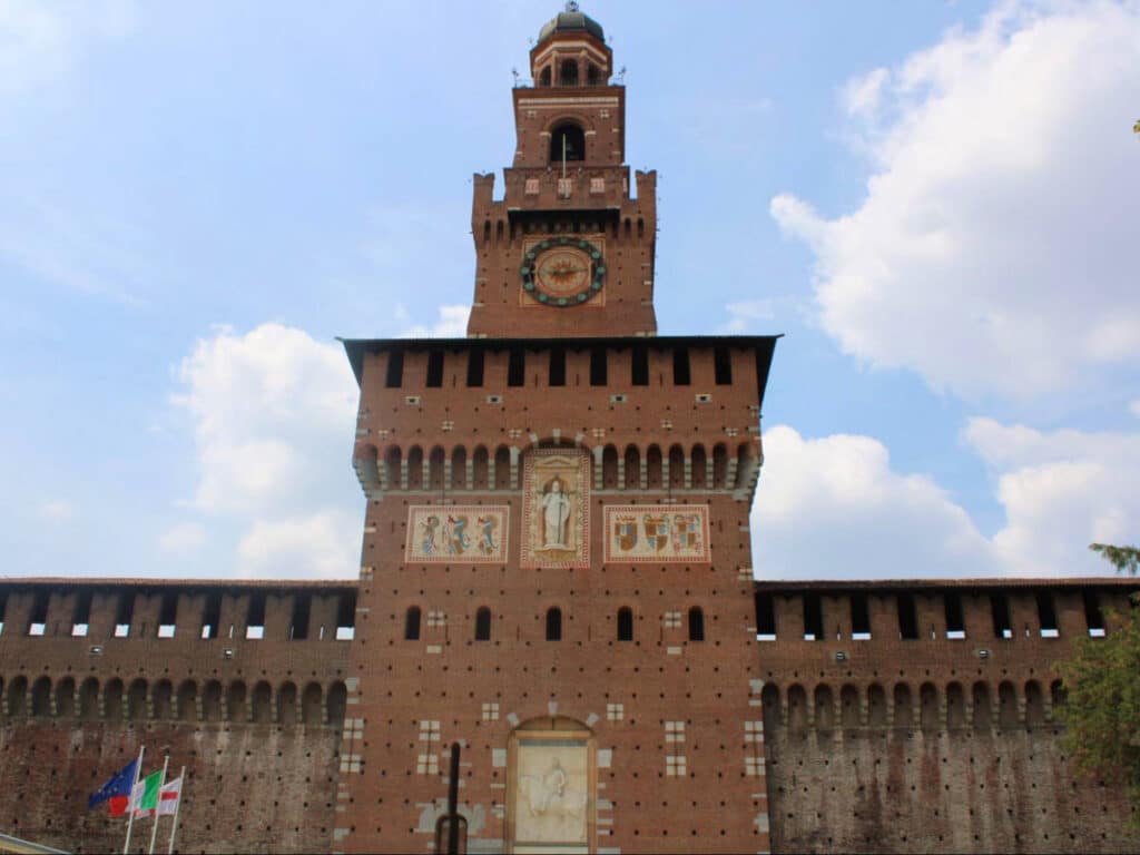 Exterior view of the Sforzesco Castle with a clocktower entrance