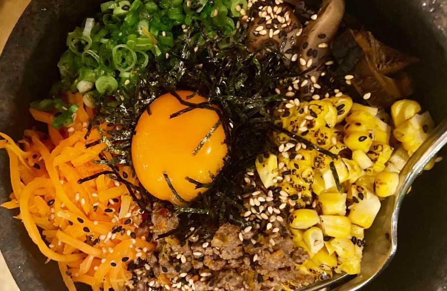A Japanese dish topped with egg yolk in Shack-Fuyu