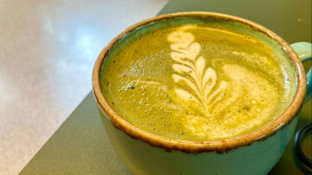 A Matcha latte with foamy art served at Shaman Coffee