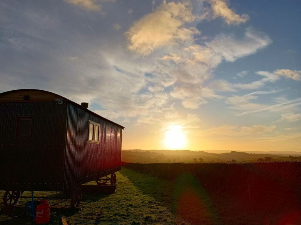 A black shed silhouetted against the sunset in Monmouthshire