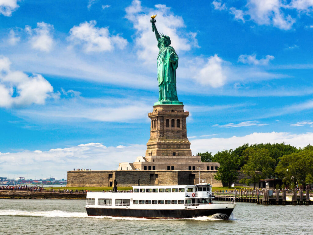 A ship sailing around the Statue of Liberty