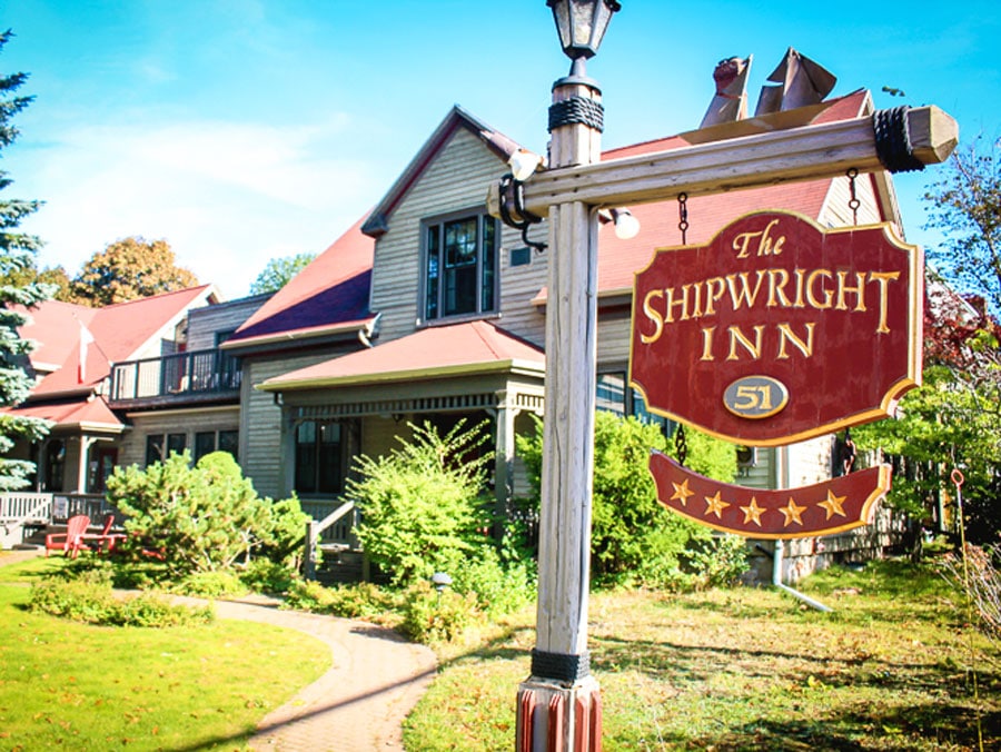 View of the Shipwright Inn from the outside and its sign