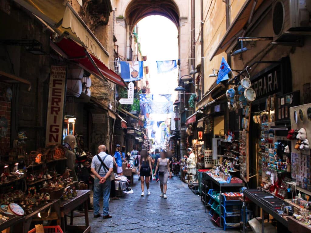 Crowd wandering around the displayed souvenirs around the shopping street of Spaccanapoli