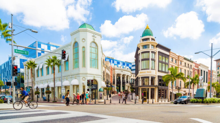 Street scene with pedestrians, cyclists, and Rodeo Drive shops