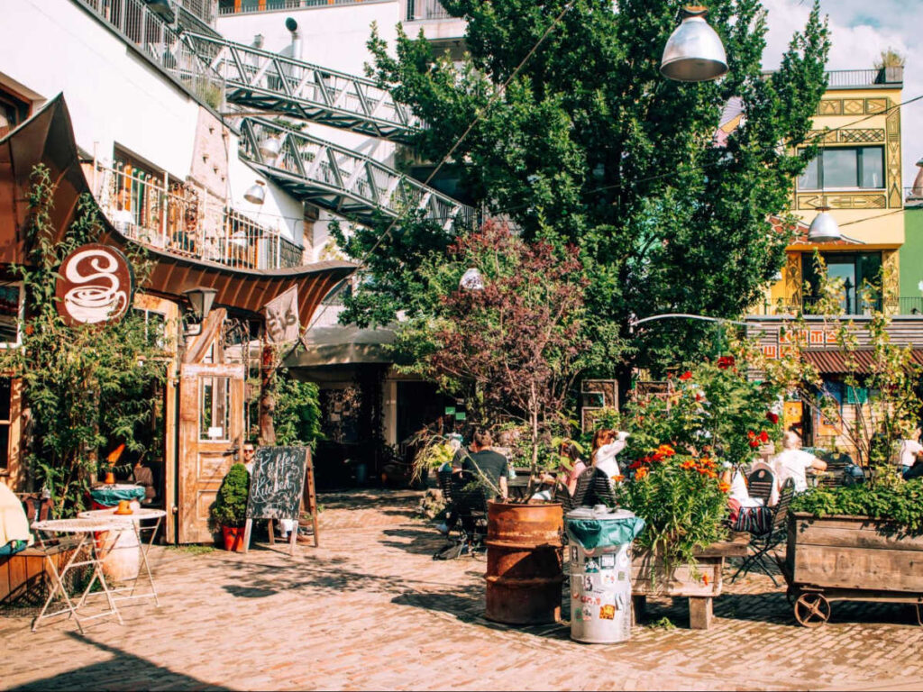 View of the greenery outside the shops and cafe at Holzmarkt