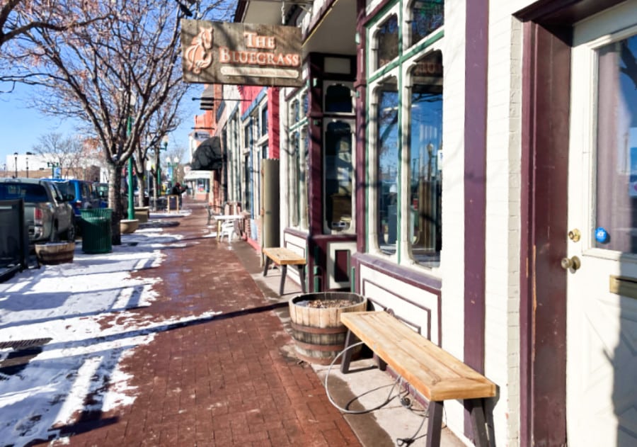 View of the empty pathway with shops and restaurants around Olde Town Arvada
