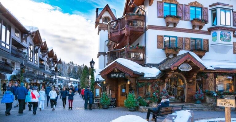 People walking in winter, among snow covered shops in downtown Vail