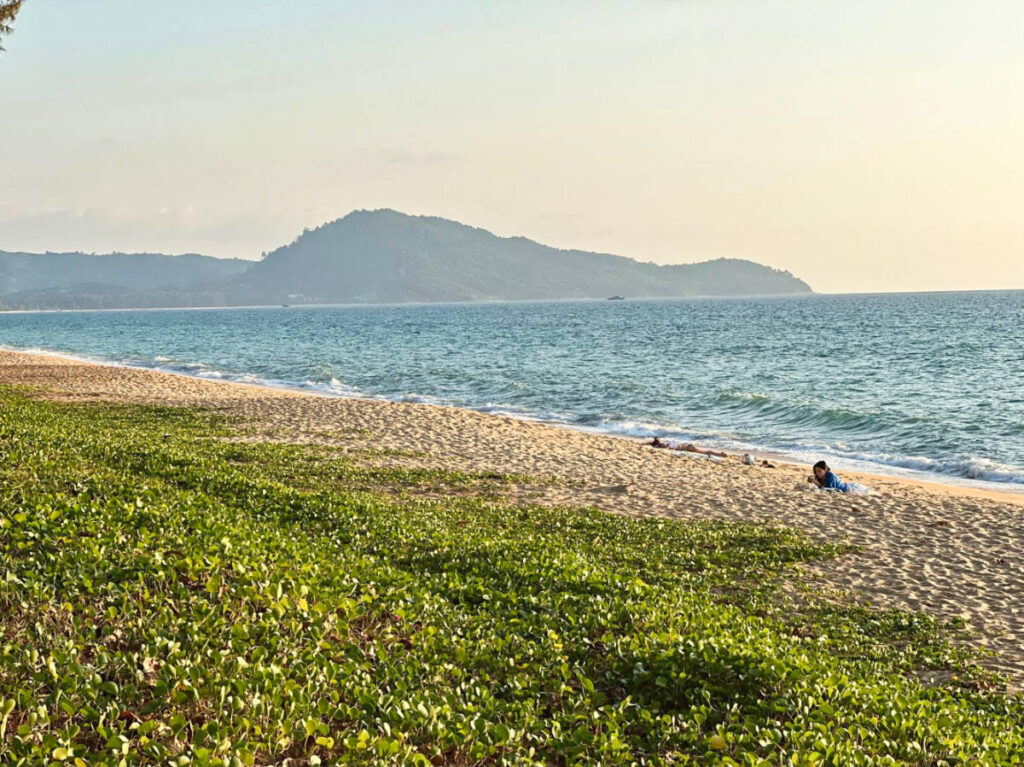 A woman relaxing along the shoreline near Le Méridien Phuket Mai Khao