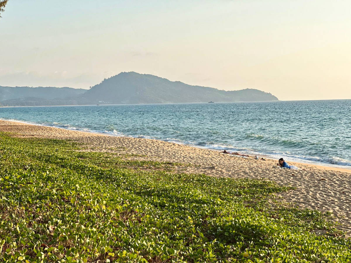 A woman relaxing along the shoreline near Le Méridien Phuket Mai Khao