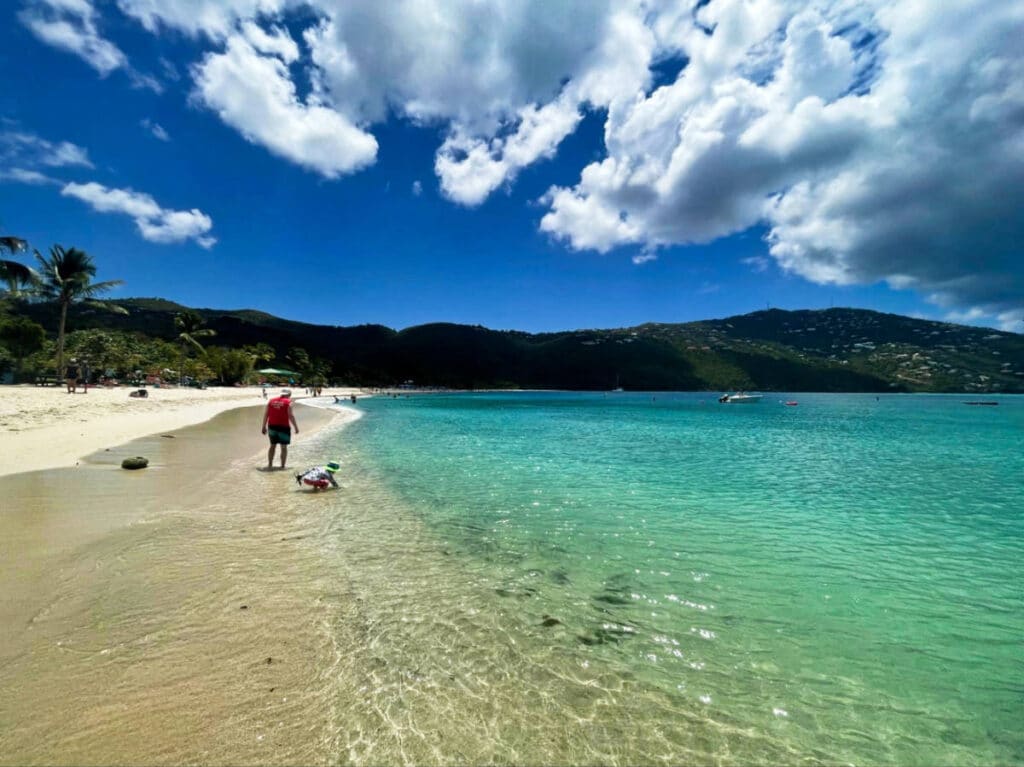 View of the tourists enjoying the turquoise water and white sand of Magens Bay Beach