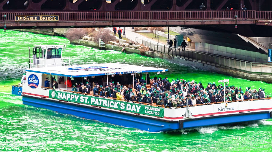 View of the tourists on the Shoreline vessel passing under the bridge in Chicago River