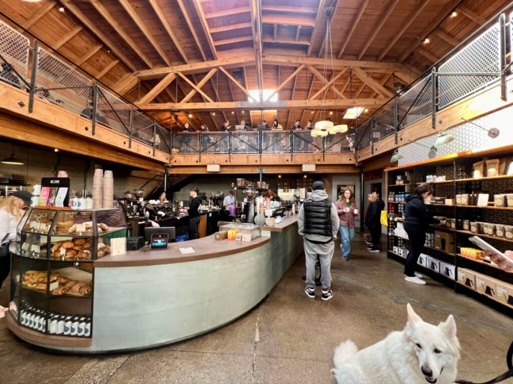 People and dog inside the Sightglass Coffee shop