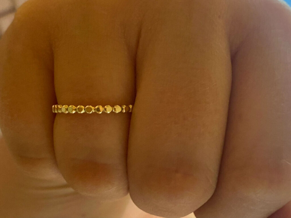Simple gold ring on authors finger