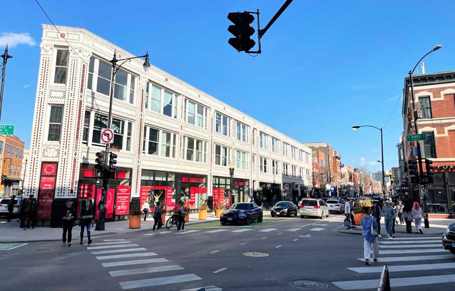 People crossing the streets in the Six Corners in Chicago