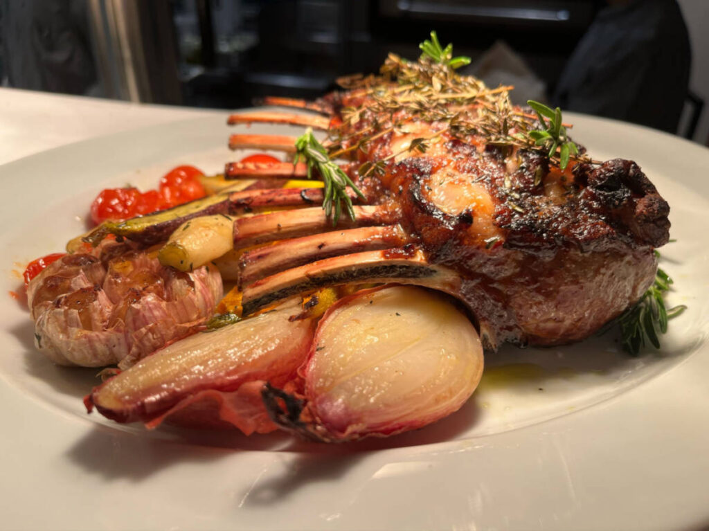 A plate with vegetables under the Skewered Filet Mignon