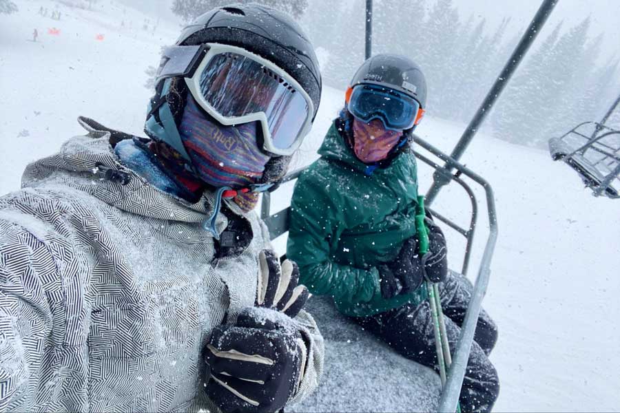 View of two people on a ski lift during winter