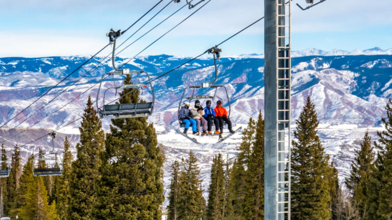 Skiers ascend the Alpine Springs chairlift at the Aspen Snowmass ski resort