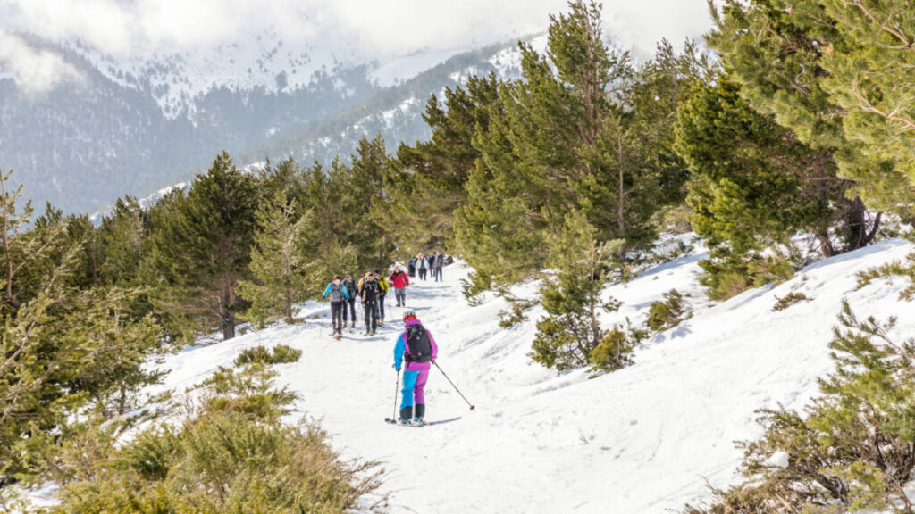 View of the skiers on the snow covered Sierra de Guadarrama National Park