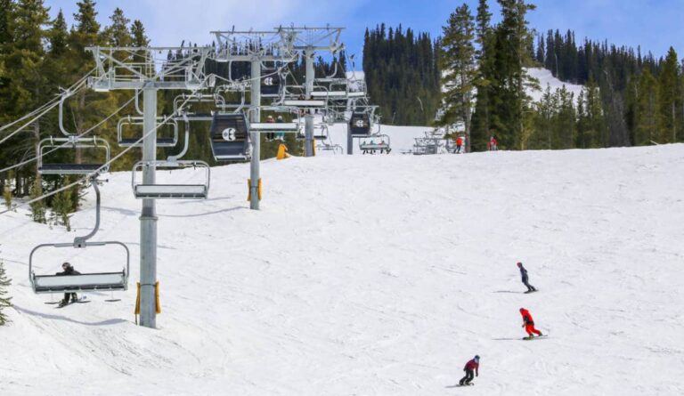 Chairlift with skiers and snowboarders on the ski slope of Copper Mountain