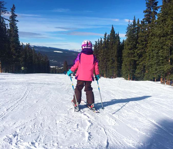 The author's daughter skiing in Denver