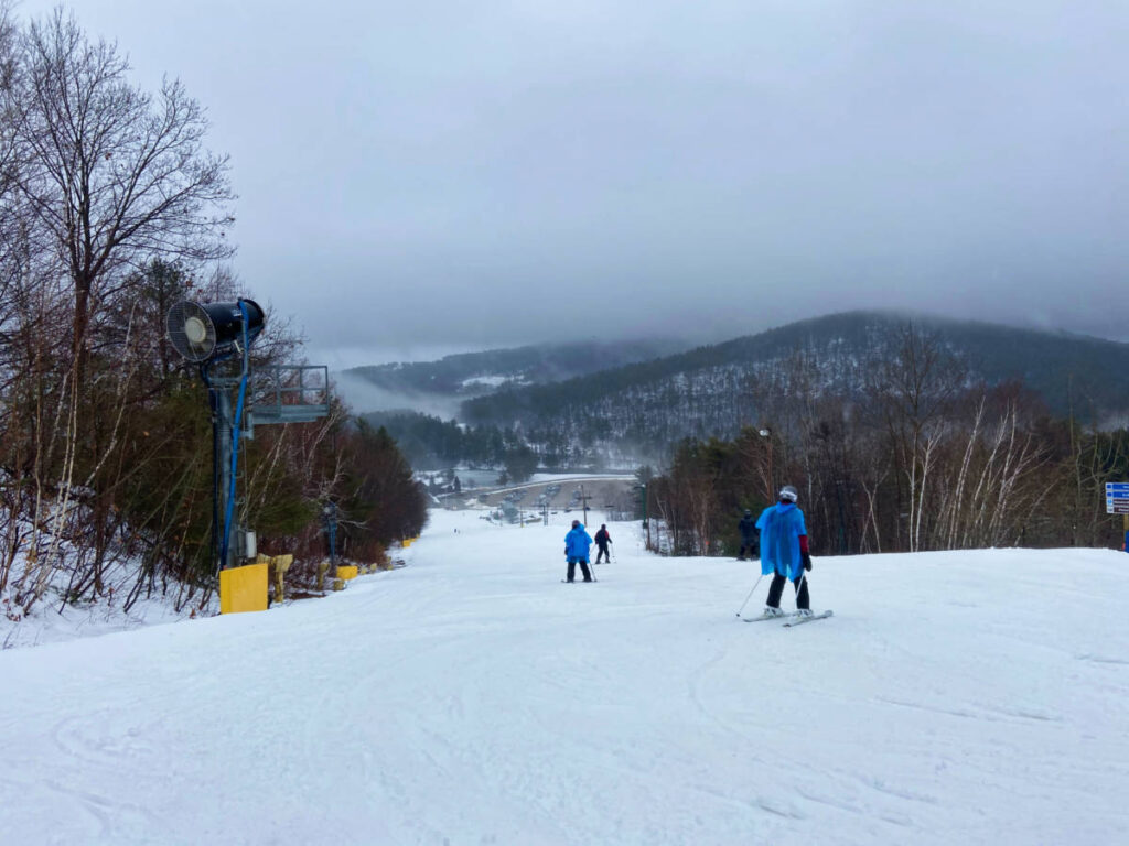 People skiing down on Gunstock Mountain
