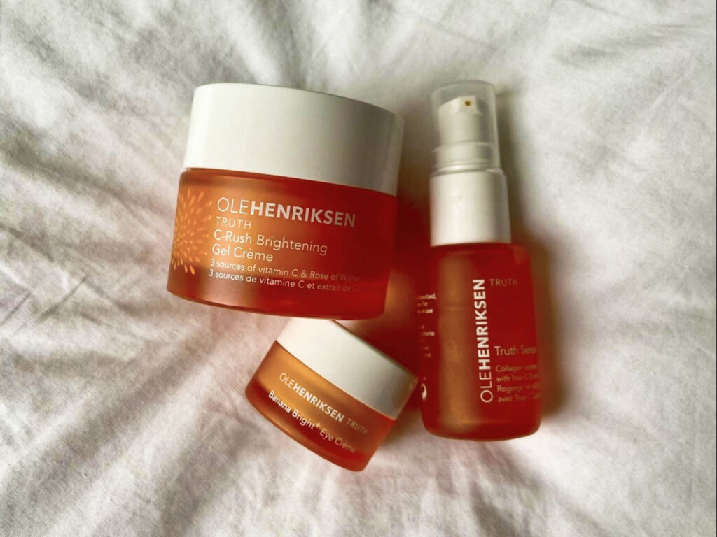Different skincare products on a white sheet