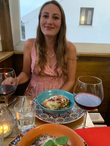 The author Sky Ariella eating lasagna at Bonta