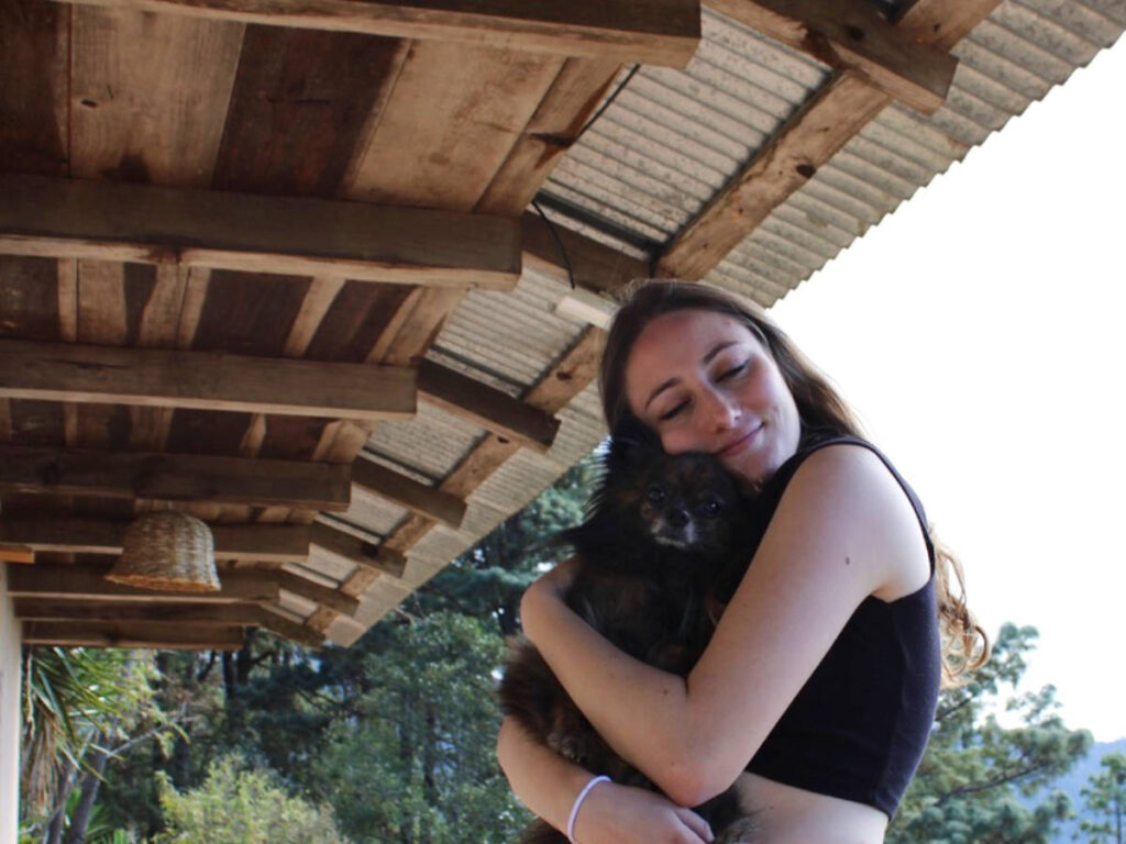Travel Lemming Writer Sky Ariella, hugging her dog