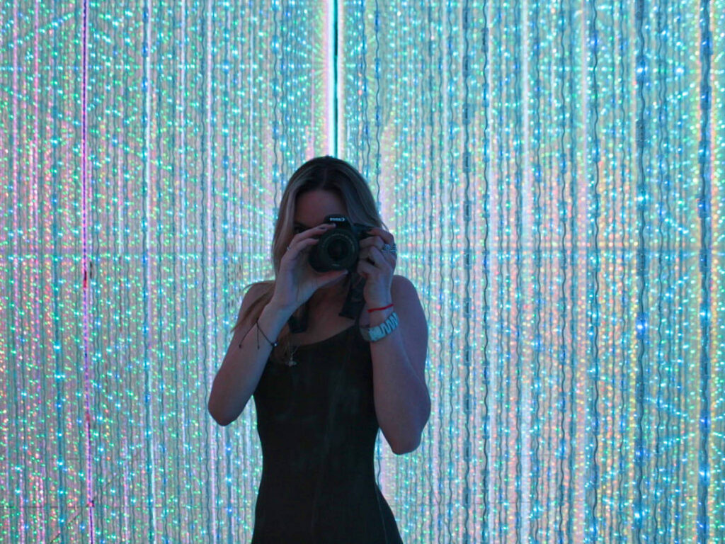 The author Sky Ariella, taking a photo with her DSLR at TeamLab Planets
