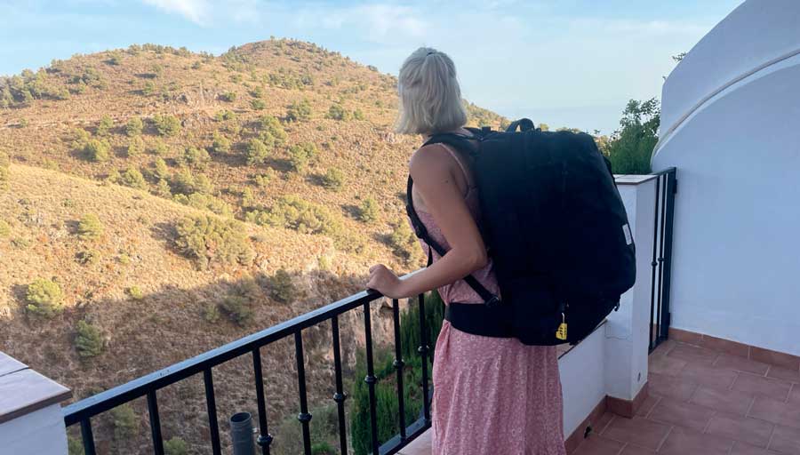 Sky carrying her Topo Designs Global Travel bag