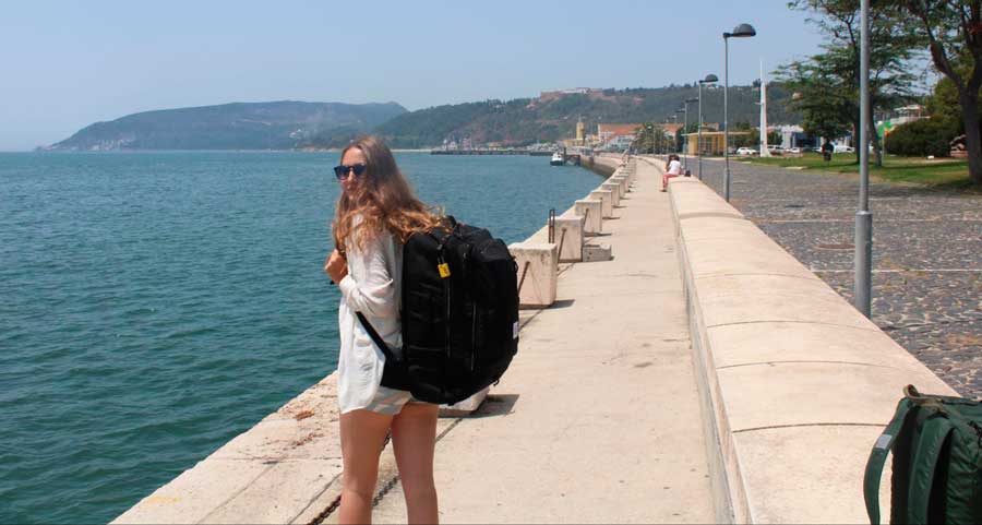 Sky posing for a photo with her Topo Designs Global Travel bag