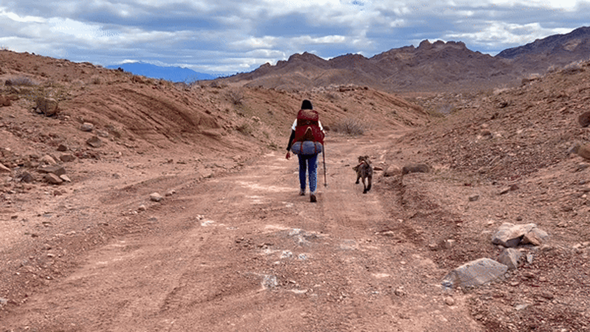 Skycie walking with her dog during a hike