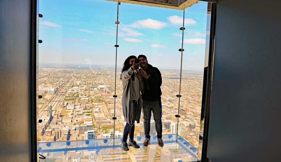 A couple taking a selfie at the Skydeck in Willis Tower