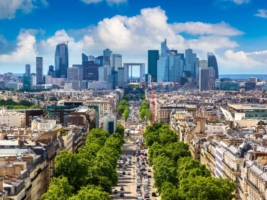 Panoramic aerial view of Paris and The Avenue Charles de Gaulle and business district of La Defence from Arc de Triomphe