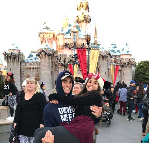 The author carried by her brother in front of Sleeping Beauty Castle