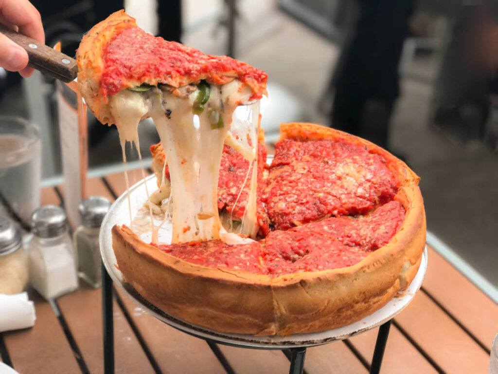 A man getting a slice of Chicago's deep-dish pizza