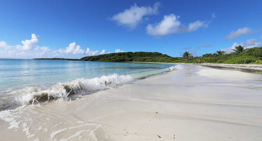View of small waves crashing to a shore in Vieques