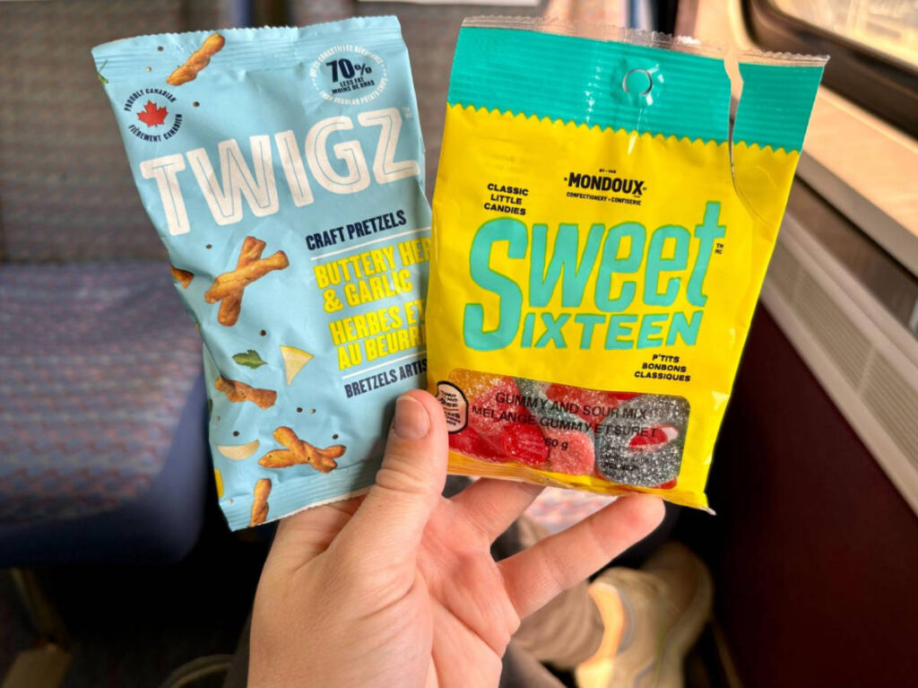 A hand holding snacks on train